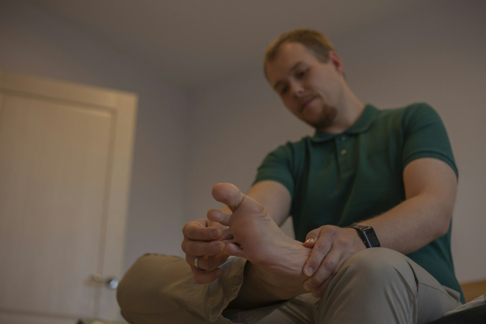 A person examining their own foot