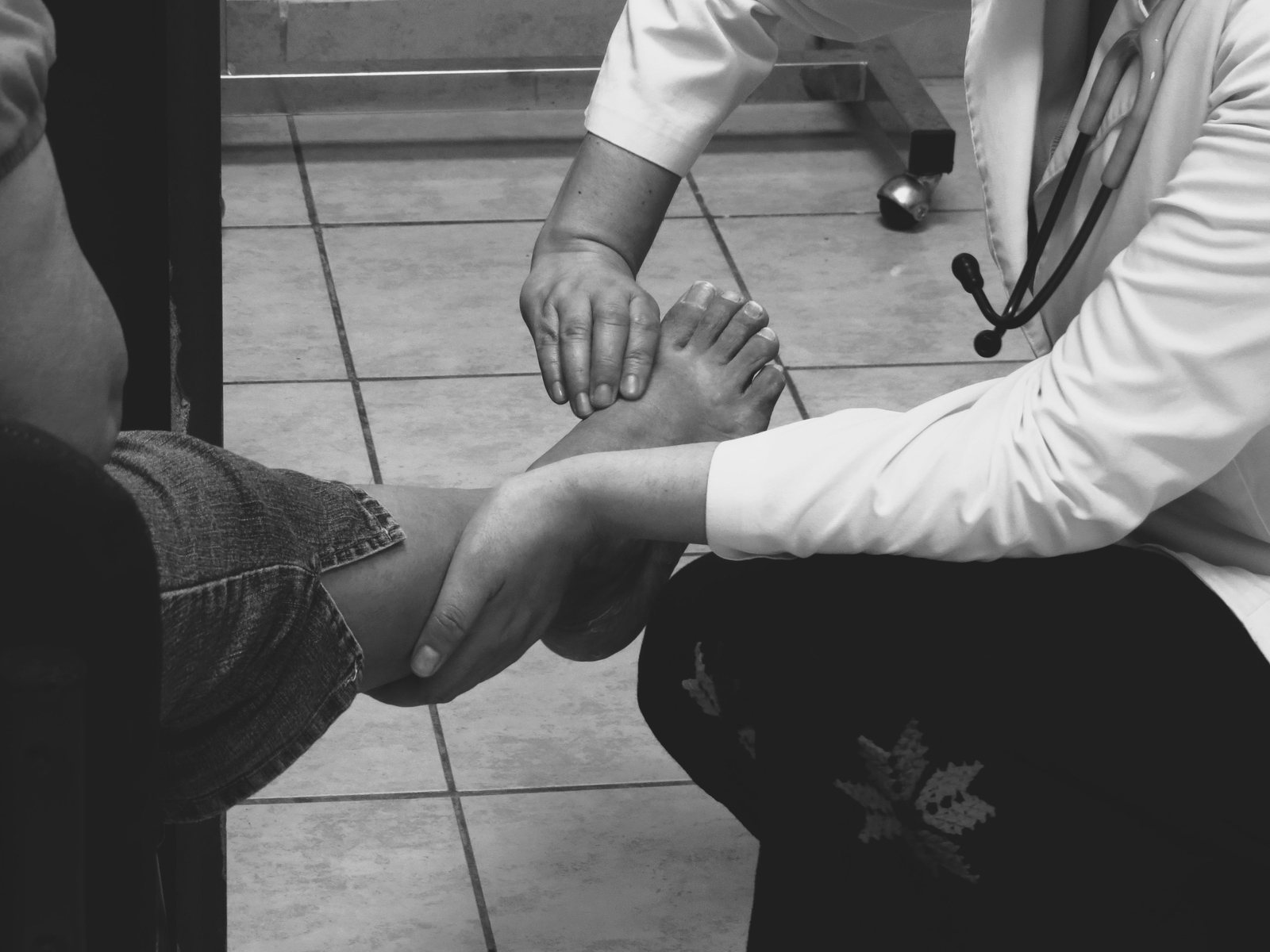 A clinician examining a patient foot