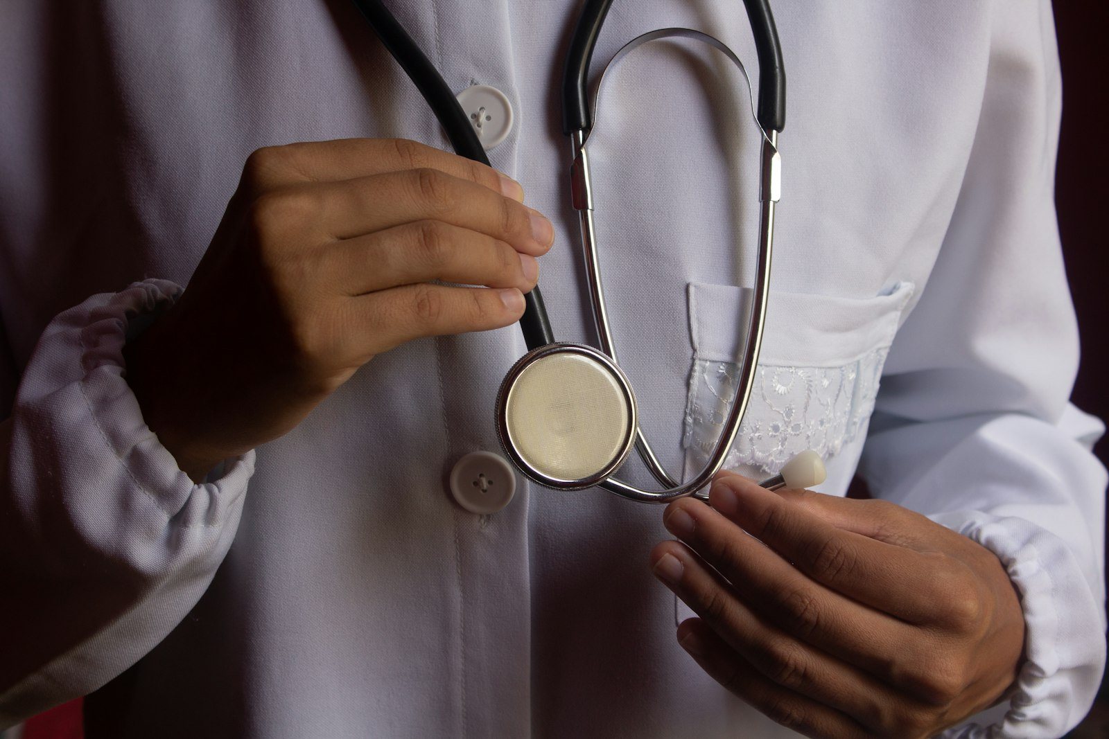 A clinician listening to a patient heart