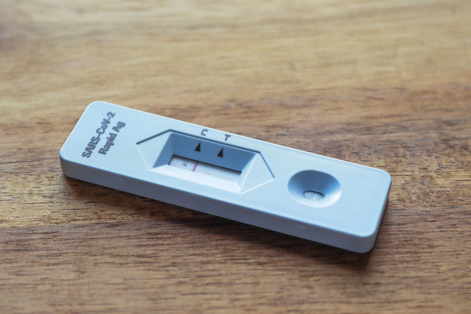 A rapid test cassette on a clinic bench