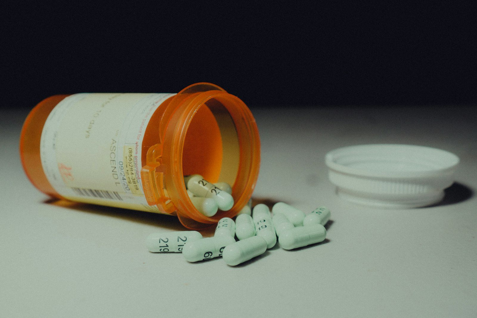 Tablets beside a prescription bottle