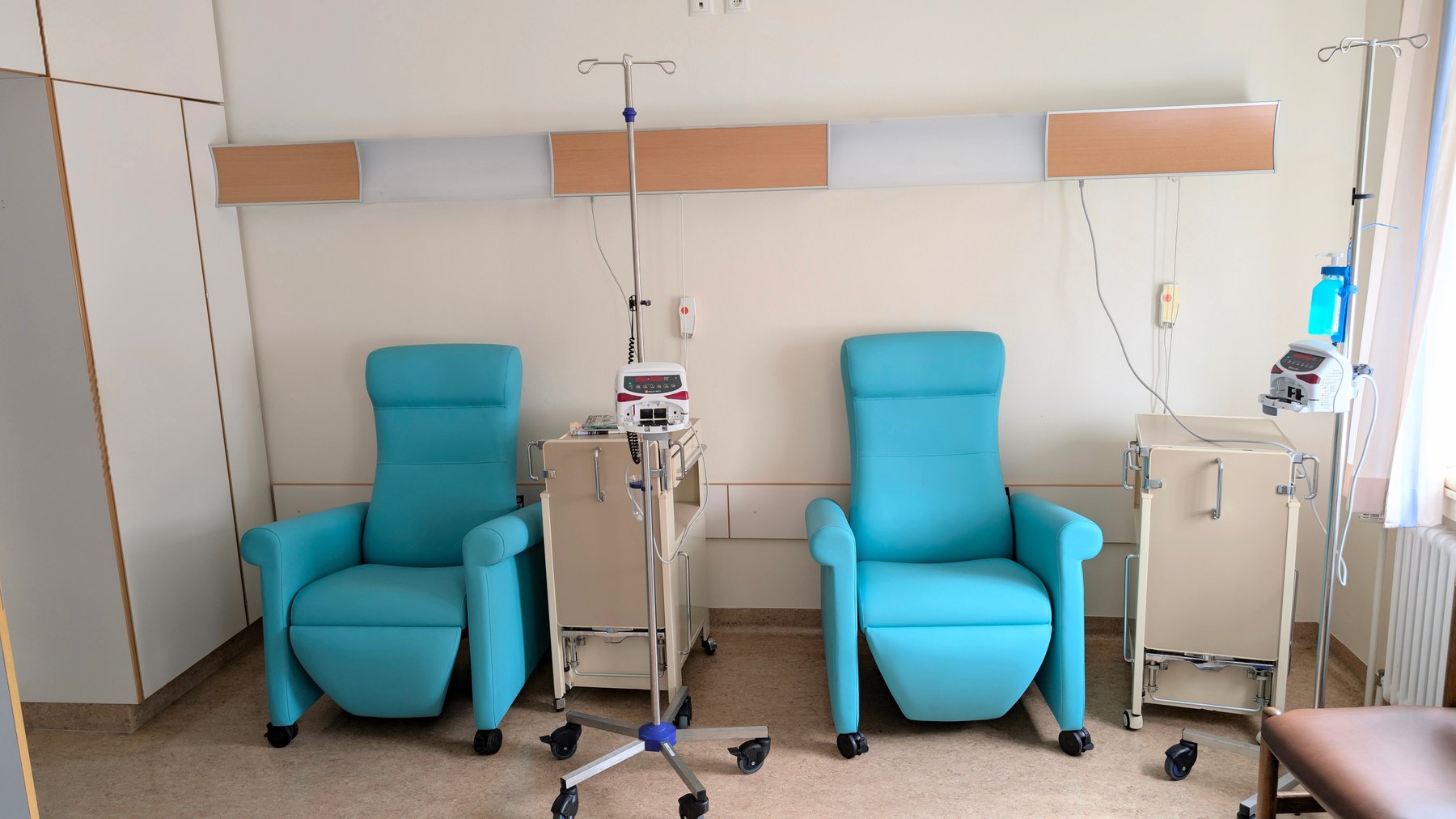 Infusion chairs and intravenous stands in a treatment room