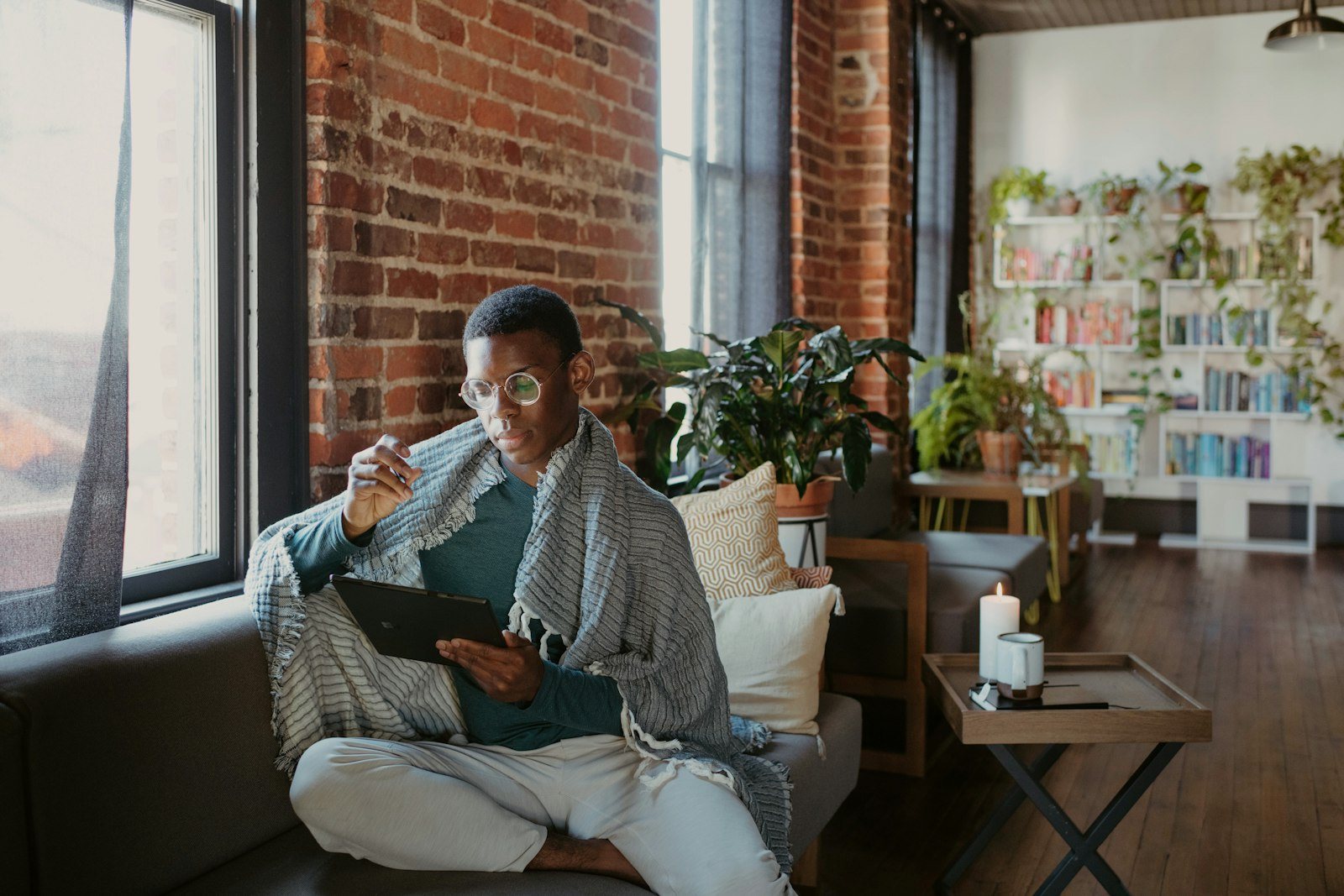 A person resting at home with a warm drink