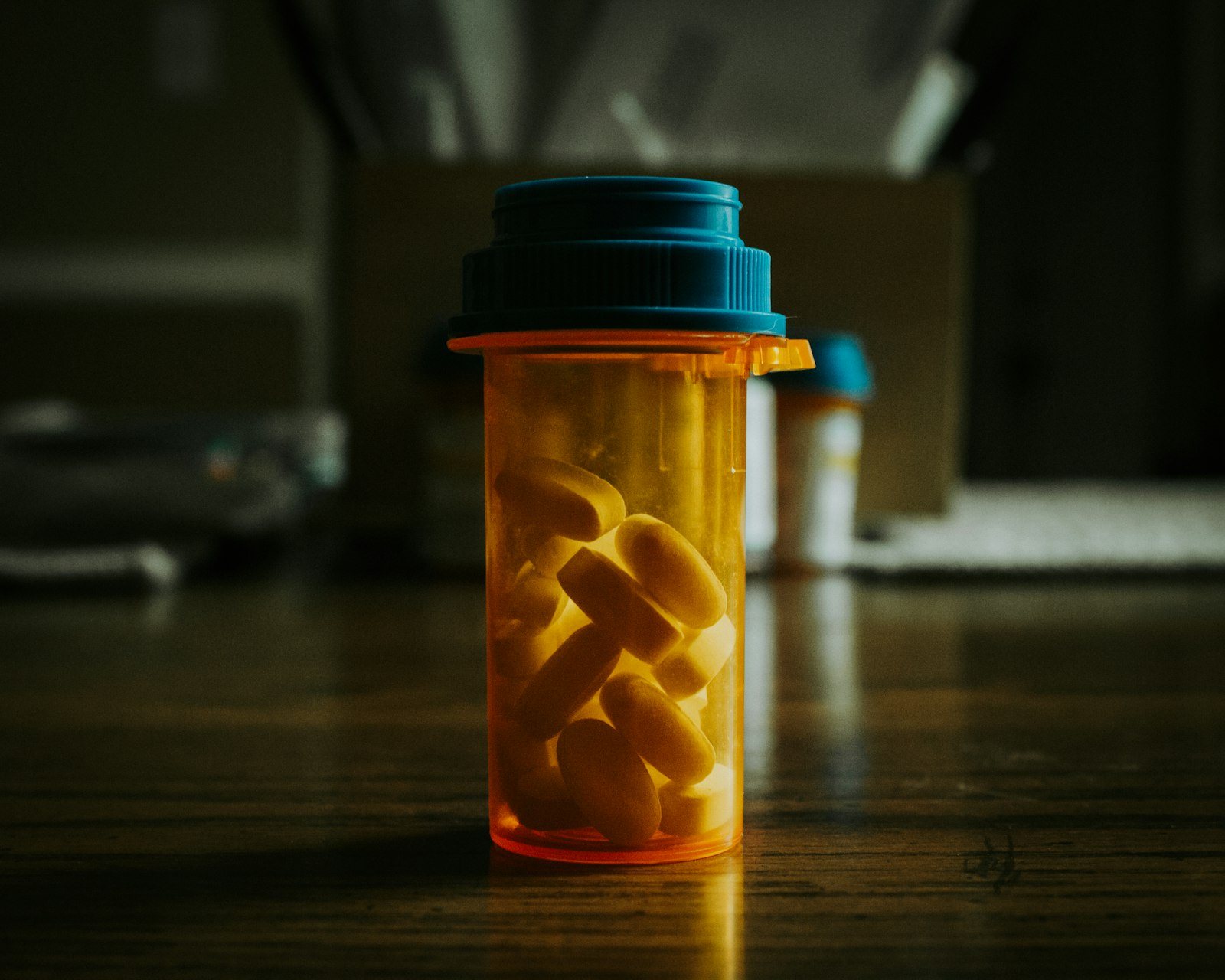 A prescription bottle with tablets