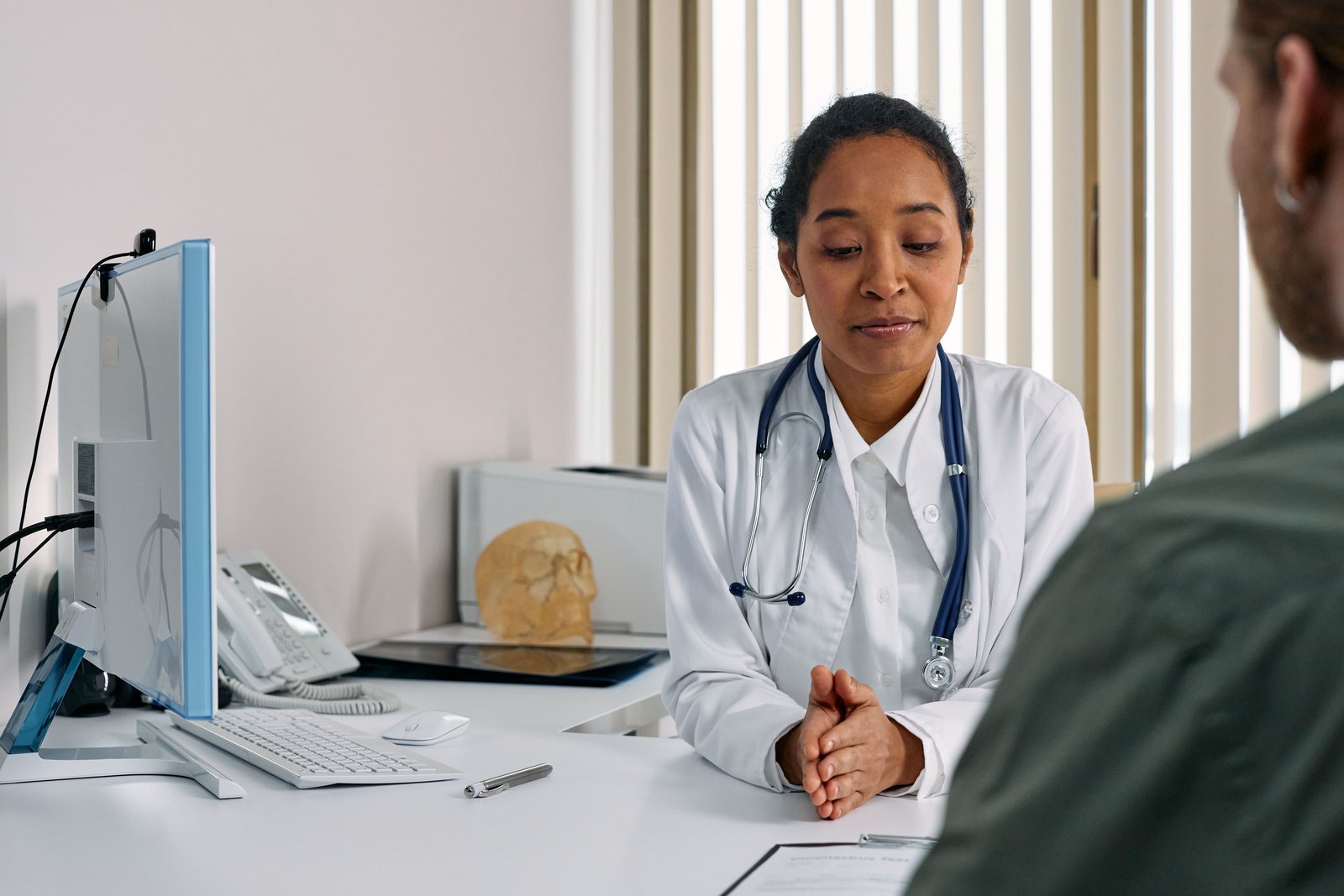 Physician reviewing a patient chart during a consultation