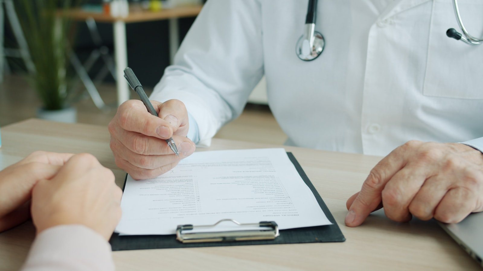 Two people talking across a consulting room table