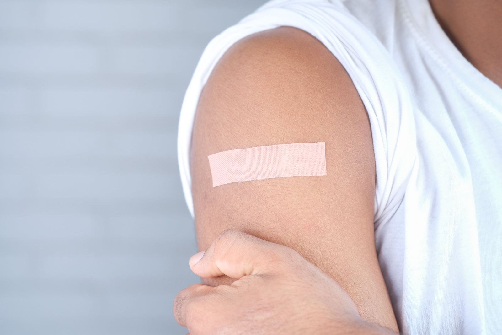 An adult receiving a vaccination in the arm