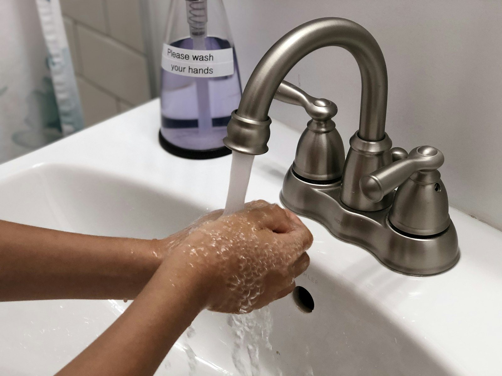 Hands being washed under running water