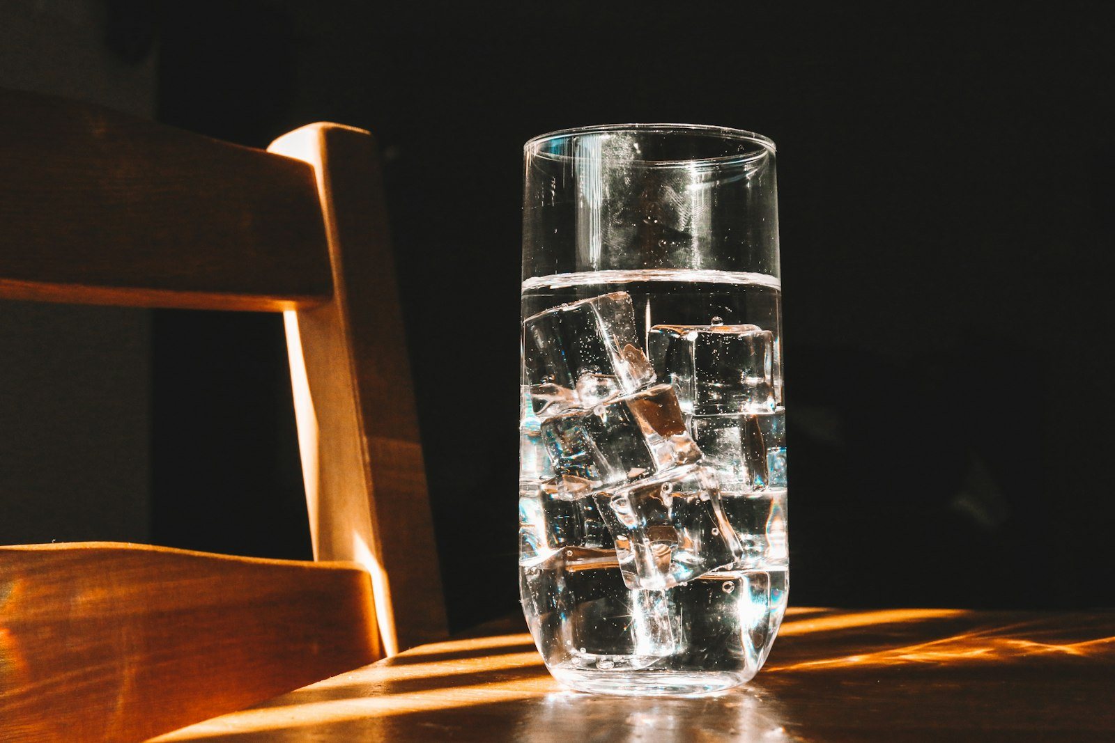 A glass of water on a wooden table