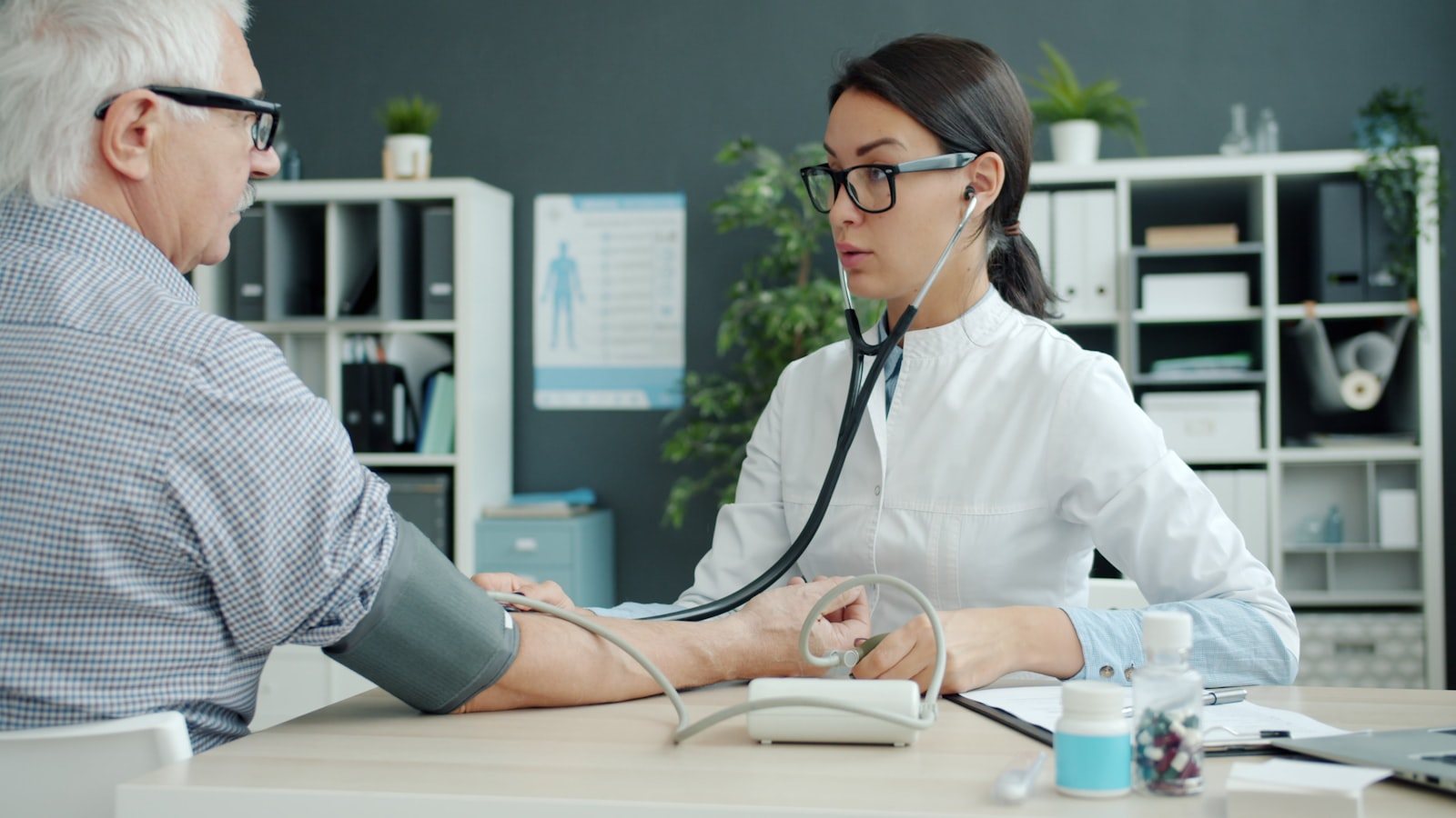 A doctor taking an older patient's blood pressure