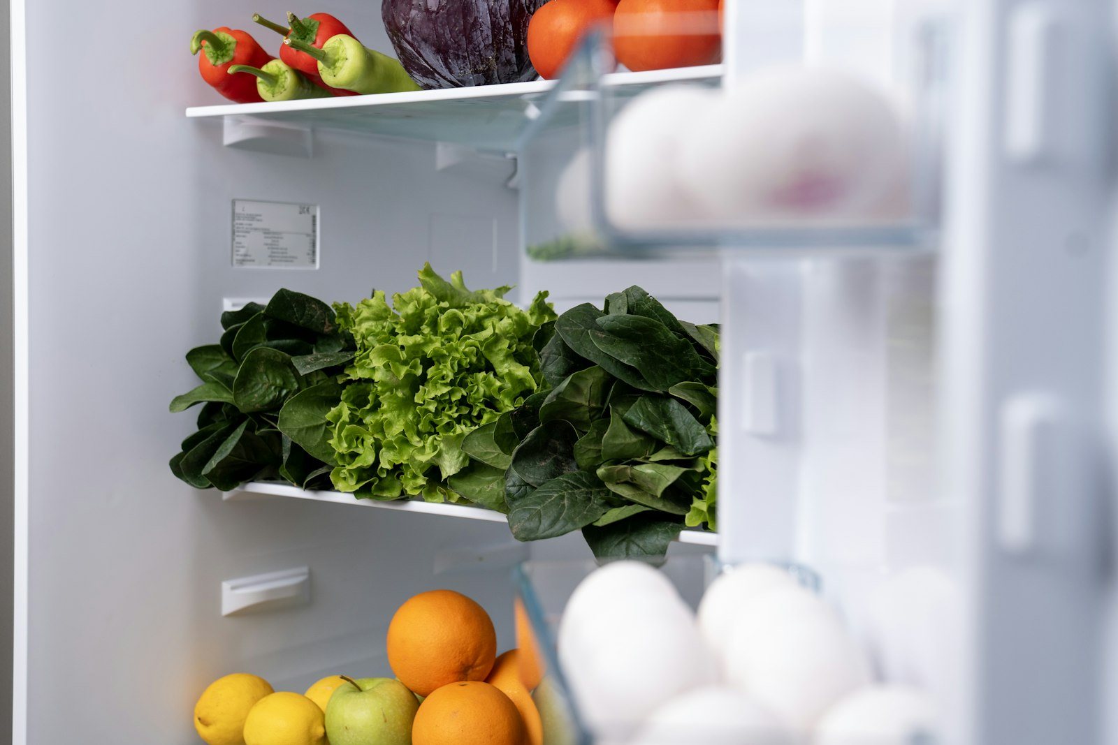 An open refrigerator stocked with fresh produce