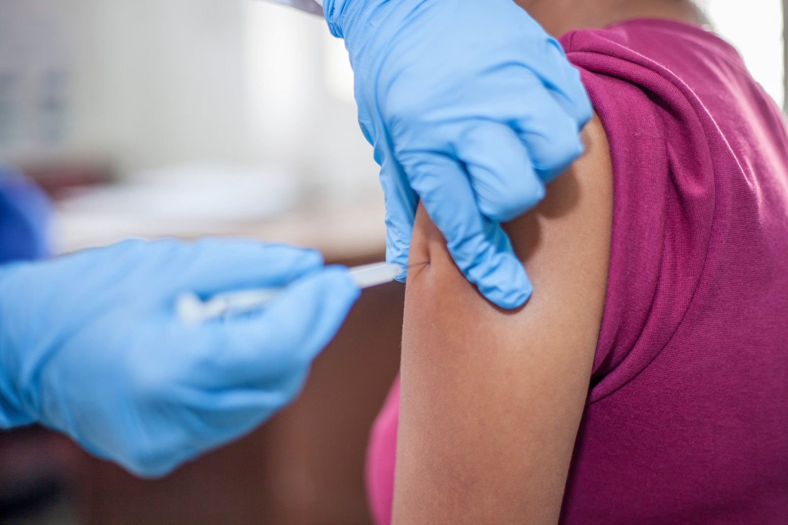 An adult receiving a vaccination in the arm