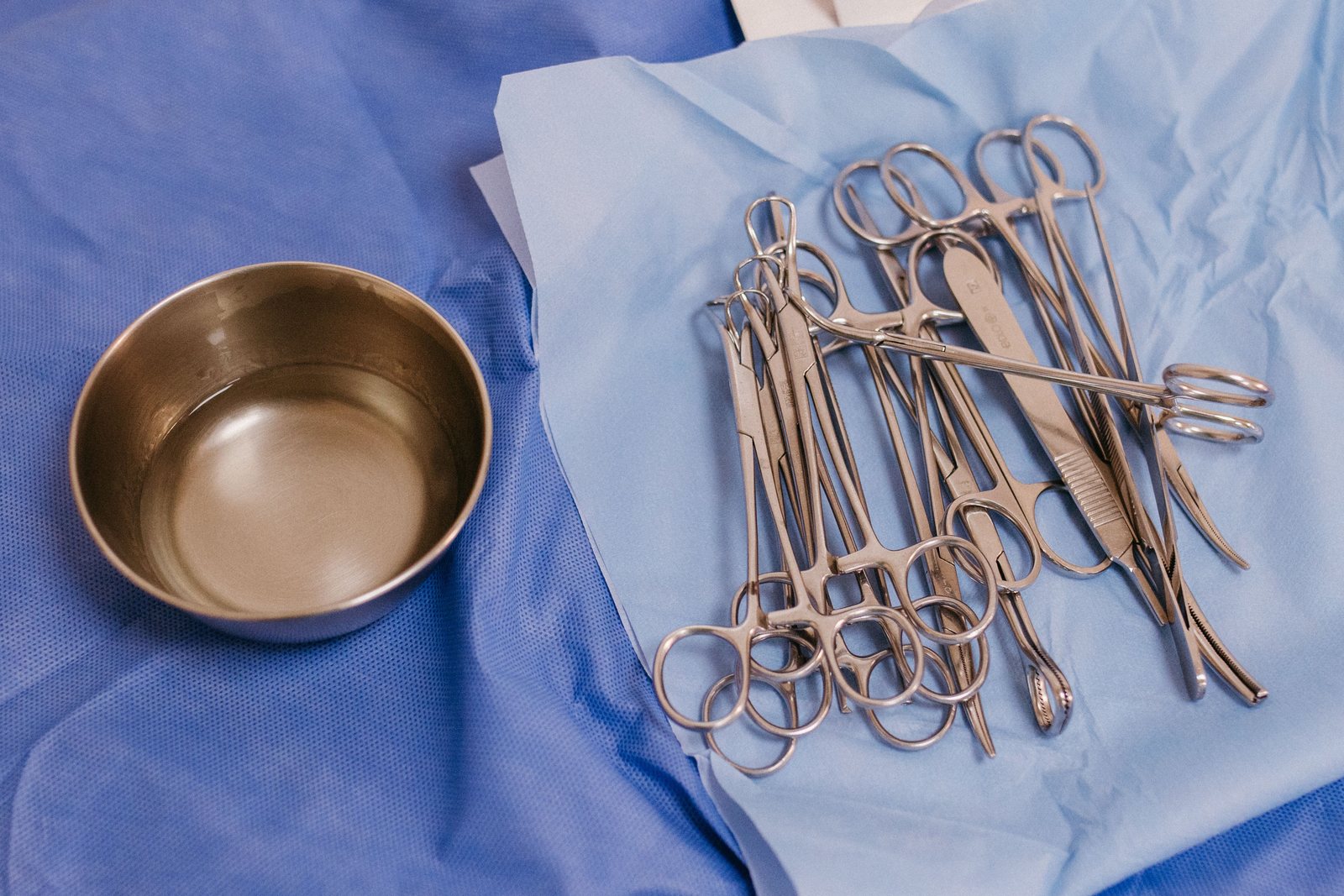 Sterile surgical instruments laid out on surgical drapes