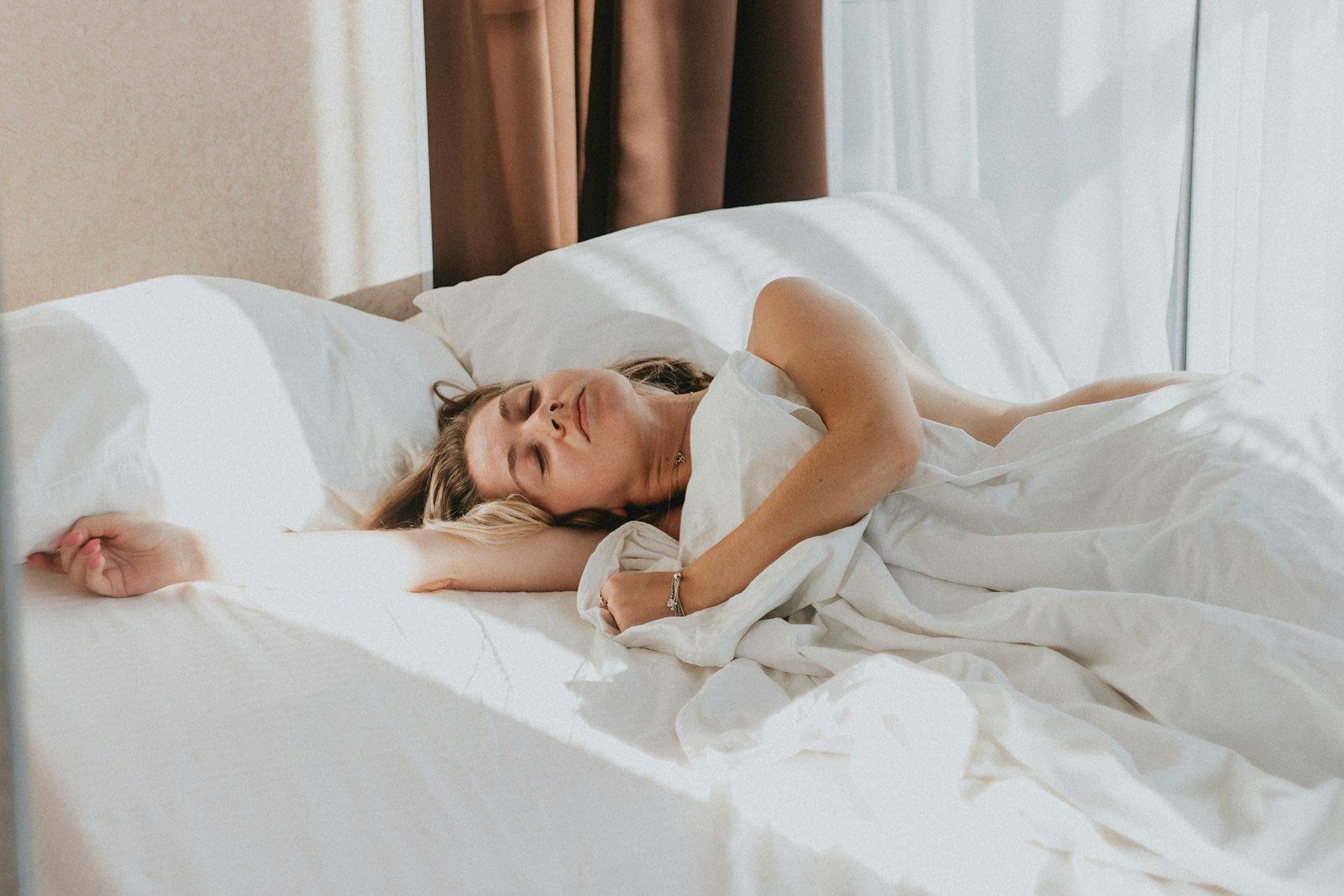 A person asleep in bed during the day