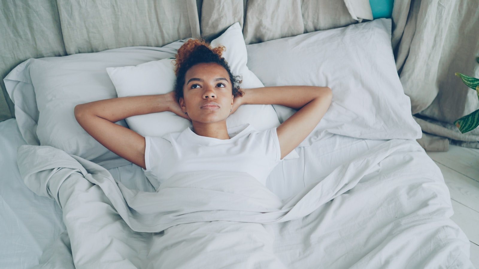 A person resting in bed at home