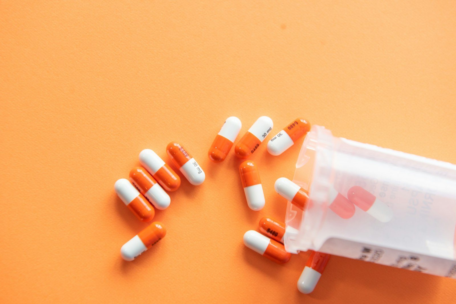 Capsules spilling from a prescription bottle