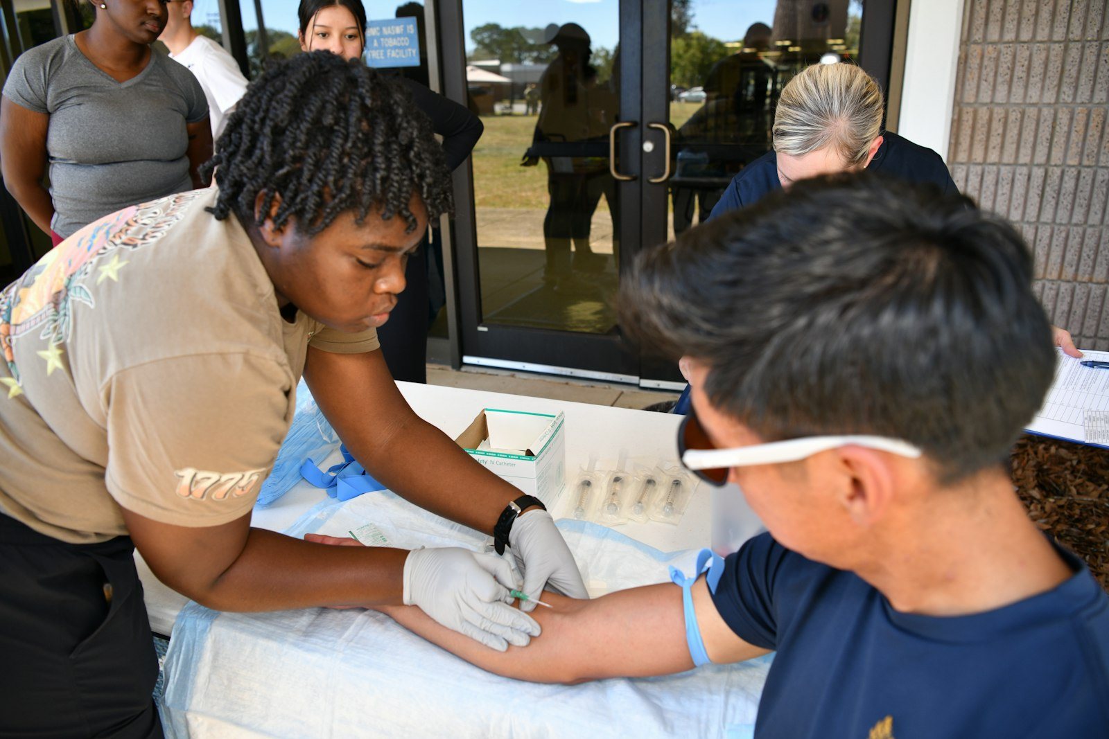 A blood sample being taken from a patient arm