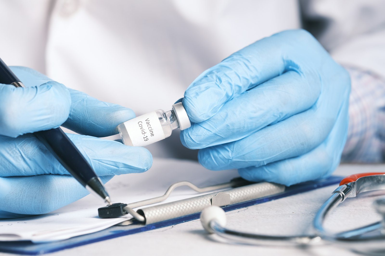 A vial and syringe prepared on a clinical tray