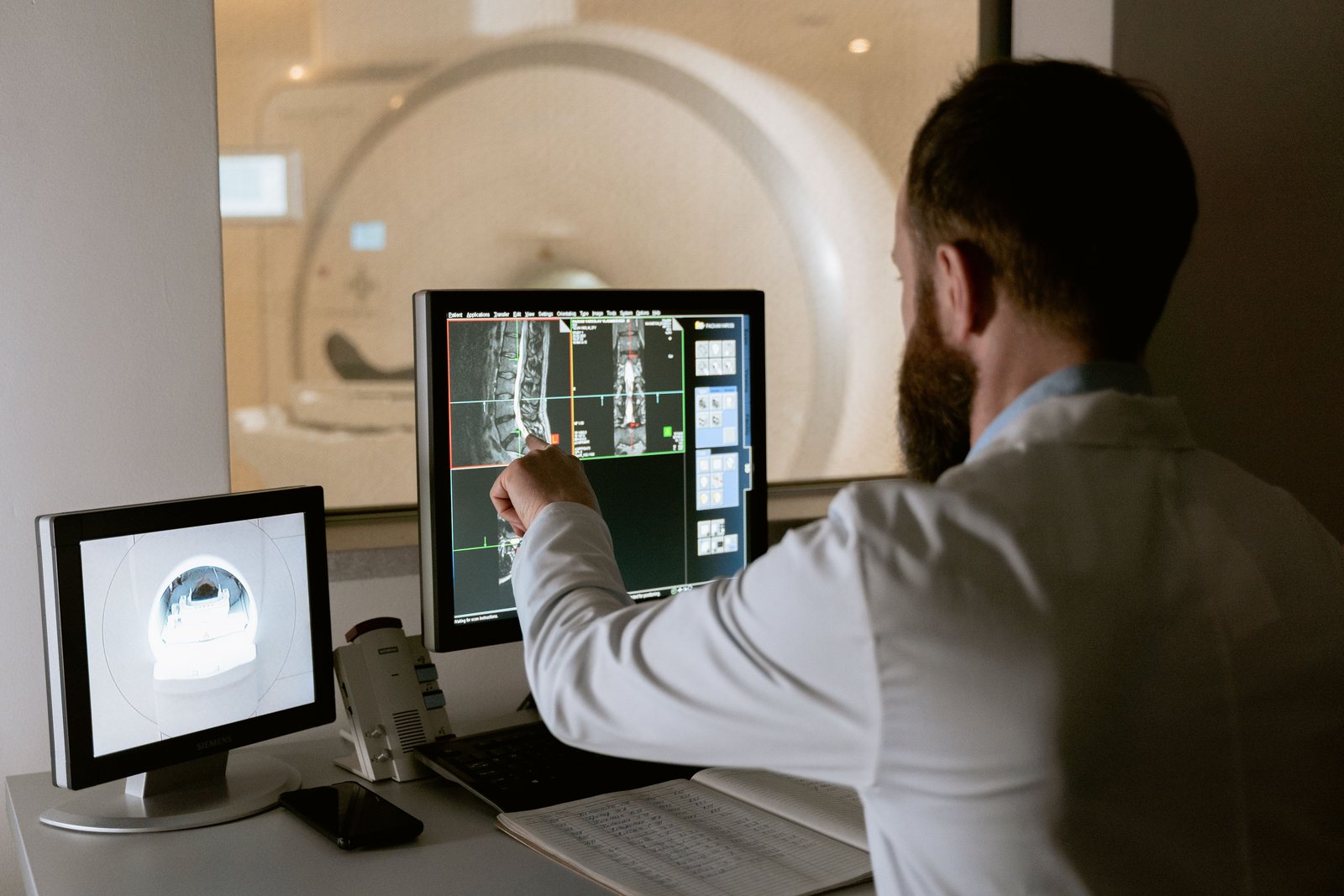 A clinician reviewing scan images on a screen